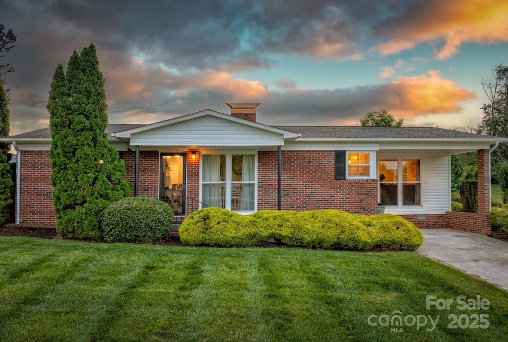 112 Meadowview Pl, Lenoir, NC 28645 - view of front of house featuring a front lawn, brick siding, and a chimney