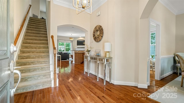 4115 Birkshire Hts, Fort Mill, SC 29708 - foyer entrance with arched walkways, wood finished floors, stairway, ornamental molding, and a chandelier