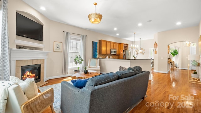 4115 Birkshire Hts, Fort Mill, SC 29708 - living room with a fireplace, light wood finished floors, arched walkways, recessed lighting, and baseboards