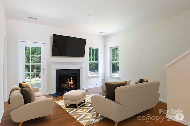 2180 Shady Pond Dr, Clover, SC 29710 - living room featuring a warm lit fireplace, baseboards, and wood finished floors
