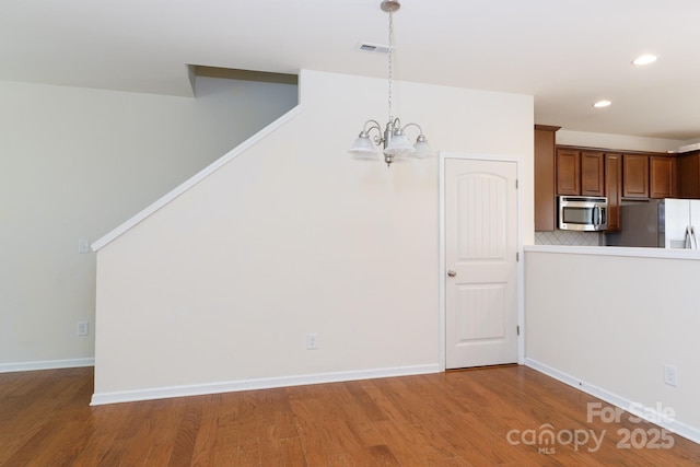 2180 Shady Pond Dr, Clover, SC 29710 - unfurnished dining area with a chandelier, wood finished floors, recessed lighting, and baseboards