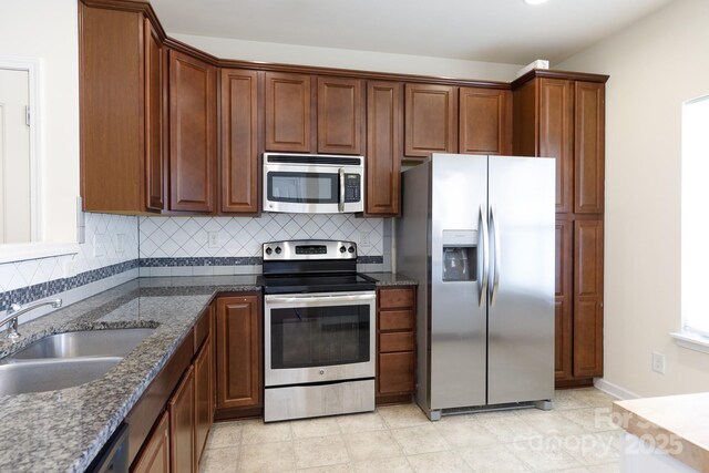 2180 Shady Pond Dr, Clover, SC 29710 - kitchen featuring appliances with stainless steel finishes, a sink, tasteful backsplash, and dark stone counters