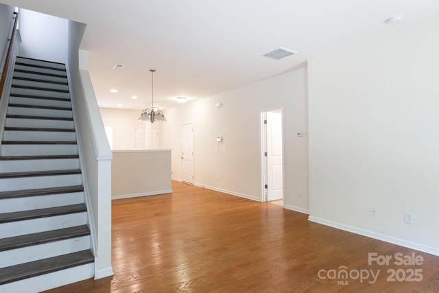 2180 Shady Pond Dr, Clover, SC 29710 - unfurnished living room featuring stairway, wood finished floors, baseboards, a chandelier, and recessed lighting