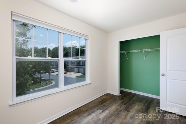 2180 Shady Pond Dr, Clover, SC 29710 - unfurnished bedroom with dark wood-style flooring, baseboards, and a closet