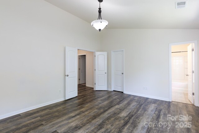 2180 Shady Pond Dr, Clover, SC 29710 - unfurnished bedroom with dark wood finished floors, baseboards, high vaulted ceiling, and ensuite bathroom