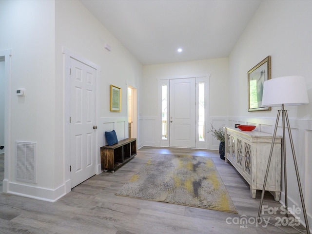 2004 Plain Field Dr, Bessemer City, NC 28016 - foyer with wood finished floors, wainscoting, recessed lighting, and a decorative wall