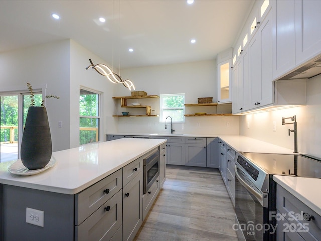 2004 Plain Field Dr, Bessemer City, NC 28016 - kitchen featuring appliances with stainless steel finishes, open shelves, gray cabinets, plenty of natural light, and recessed lighting