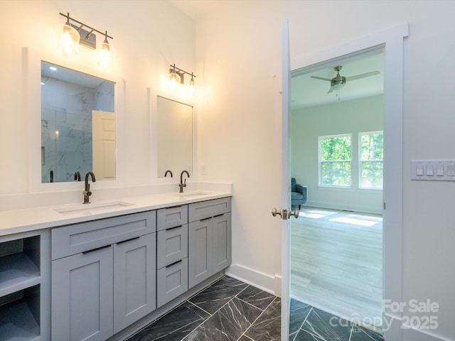 2004 Plain Field Dr, Bessemer City, NC 28016 - full bathroom featuring double vanity, a marble finish shower, marble look tile flooring, ceiling fan, and baseboards
