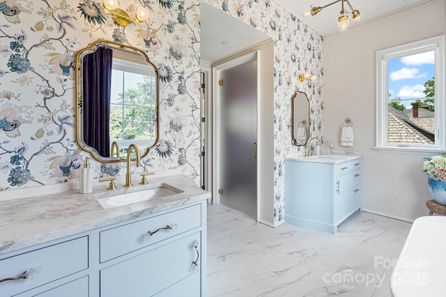 1172 Queens Rd, Charlotte, NC 28207 - bathroom featuring wallpapered walls, two vanities, baseboards, and marble finish flooring