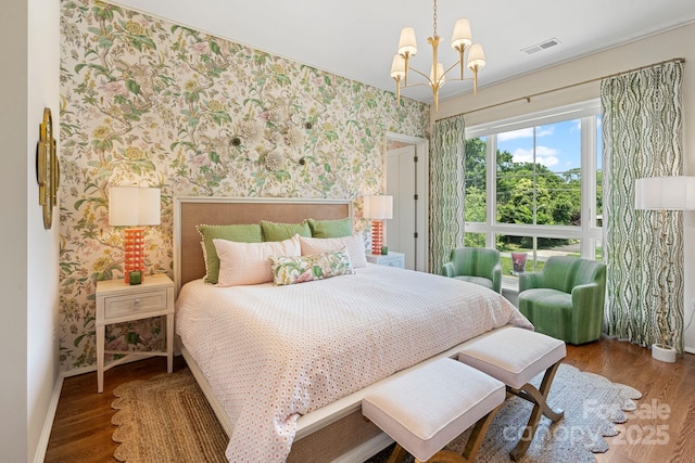 1172 Queens Rd, Charlotte, NC 28207 - bedroom with wallpapered walls, baseboards, a chandelier, and wood finished floors