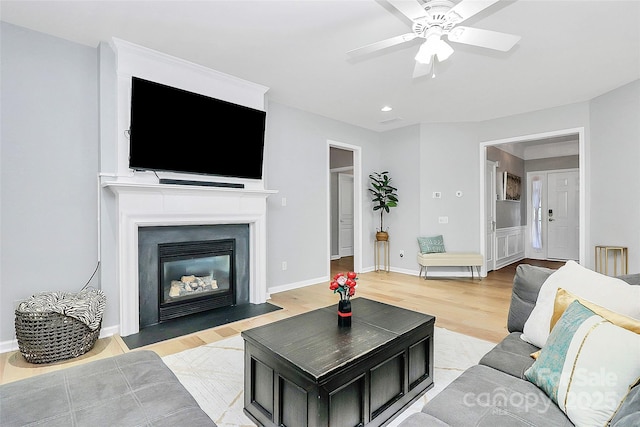 8722 Heron Glen Dr, Charlotte, NC 28269 - living room with a ceiling fan, light wood-style floors, recessed lighting, a fireplace with flush hearth, and baseboards