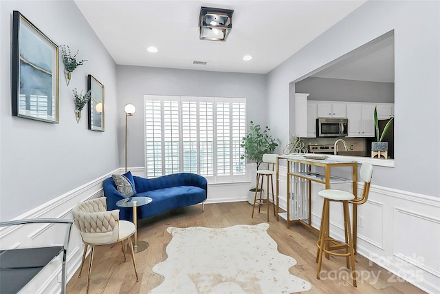 8722 Heron Glen Dr, Charlotte, NC 28269 - sitting room with wood finished floors and wainscoting