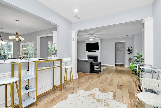 8722 Heron Glen Dr, Charlotte, NC 28269 - kitchen with a ceiling fan, light wood finished floors, a fireplace, baseboards, and recessed lighting