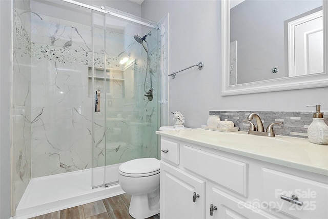 8722 Heron Glen Dr, Charlotte, NC 28269 - full bath with vanity, toilet, a marble finish shower, wood finished floors, and decorative backsplash