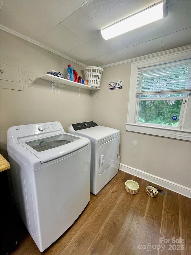 106 Peacock Ave, Lexington, NC 27292 - laundry area featuring separate washer and dryer, wood finished floors, ornamental molding, and baseboards
