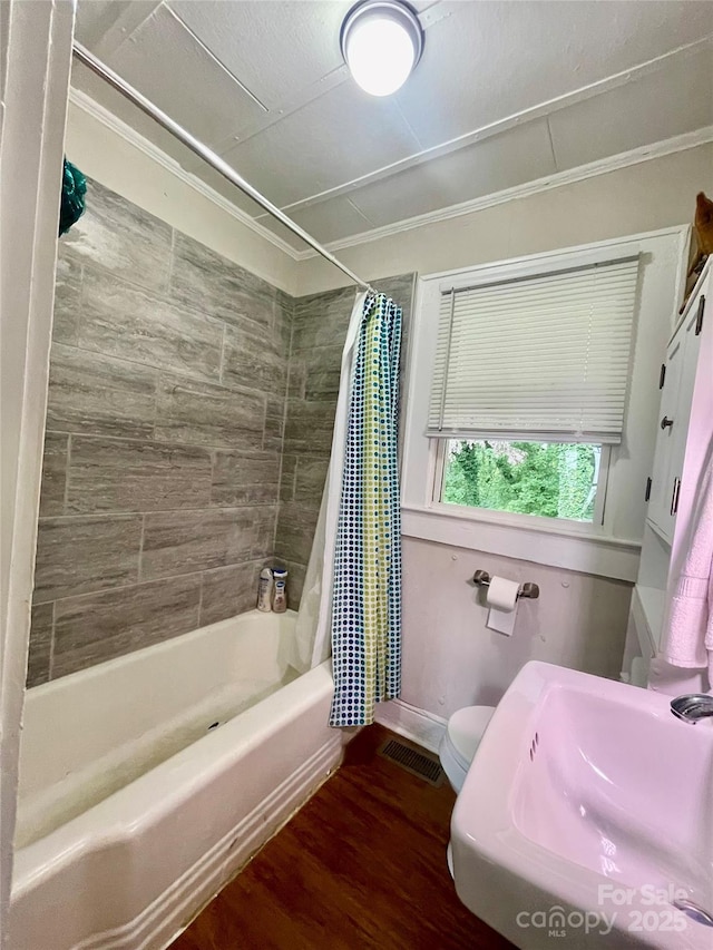 106 Peacock Ave, Lexington, NC 27292 - full bathroom with a sink, shower / bath combo, wood finished floors, toilet, and baseboards
