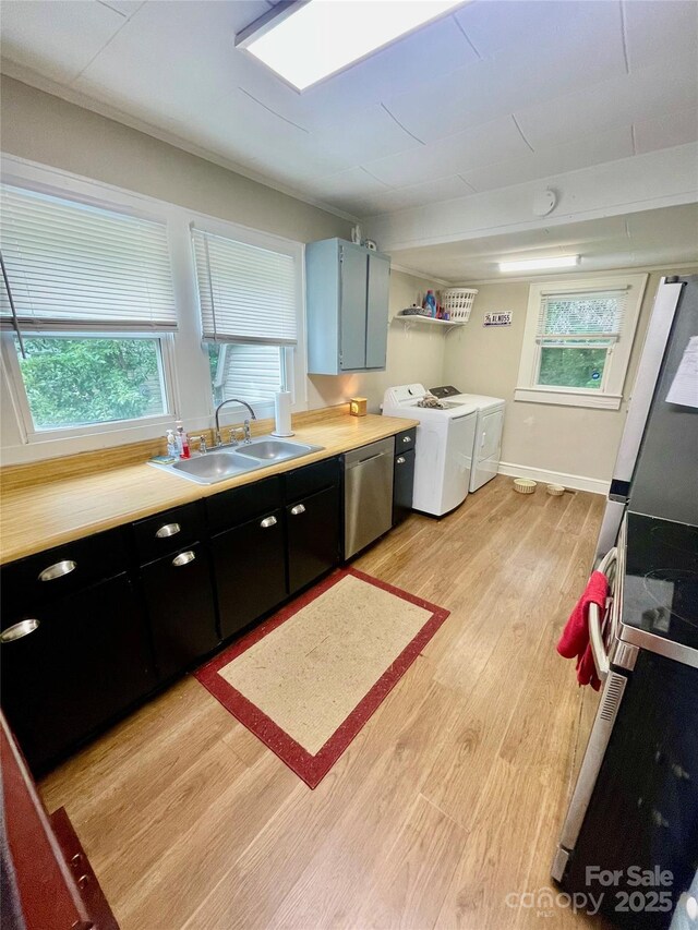 106 Peacock Ave, Lexington, NC 27292 - kitchen featuring dishwasher, independent washer and dryer, a sink, light wood finished floors, and light countertops