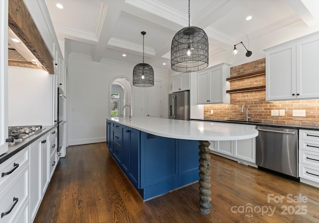 1108 Shinnecock Ln, Waxhaw, NC 28173 - kitchen with appliances with stainless steel finishes, coffered ceiling, arched walkways, custom range hood, and blue cabinets