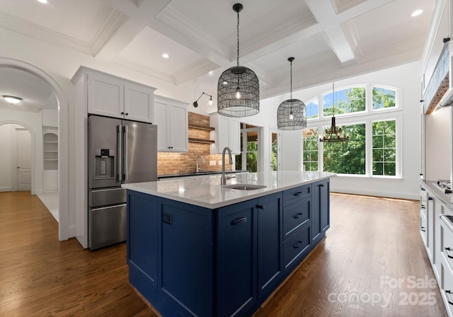1108 Shinnecock Ln, Waxhaw, NC 28173 - kitchen with stainless steel fridge with ice dispenser, coffered ceiling, blue cabinetry, dark wood-style floors, and backsplash