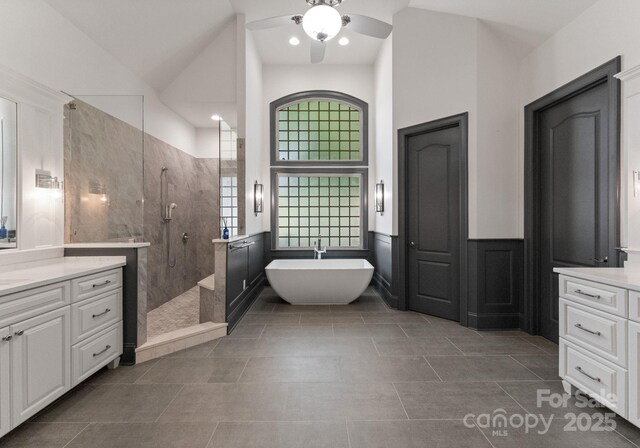 1108 Shinnecock Ln, Waxhaw, NC 28173 - bathroom featuring a ceiling fan, walk in shower, vanity, a freestanding tub, and tile patterned floors