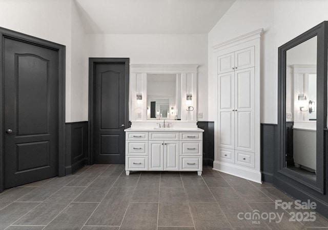 1108 Shinnecock Ln, Waxhaw, NC 28173 - bathroom featuring wainscoting, vanity, and a decorative wall