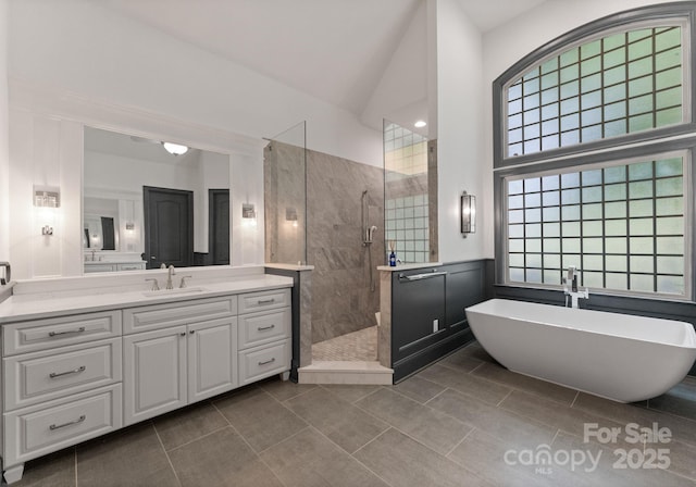 1108 Shinnecock Ln, Waxhaw, NC 28173 - bathroom with a walk in shower, vanity, a soaking tub, high vaulted ceiling, and tile patterned floors