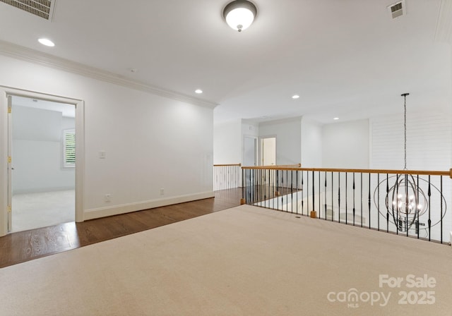 1108 Shinnecock Ln, Waxhaw, NC 28173 - unfurnished room with crown molding, wood finished floors, recessed lighting, and a chandelier