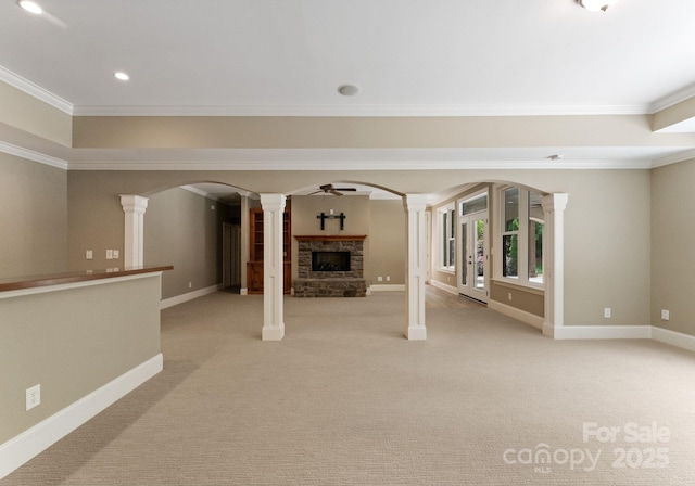 1108 Shinnecock Ln, Waxhaw, NC 28173 - unfurnished living room with ornate columns, ornamental molding, light carpet, a fireplace with raised hearth, and ceiling fan