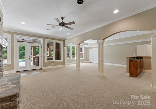 1108 Shinnecock Ln, Waxhaw, NC 28173 - unfurnished living room with decorative columns, arched walkways, ceiling fan, ornamental molding, and recessed lighting