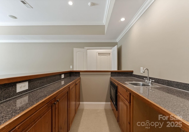 1108 Shinnecock Ln, Waxhaw, NC 28173 - kitchen featuring brown cabinets, dark countertops, ornamental molding, recessed lighting, and black microwave