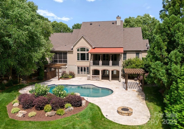 1108 Shinnecock Ln, Waxhaw, NC 28173 - back of property featuring a balcony, stucco siding, a patio area, a chimney, and an outdoor pool