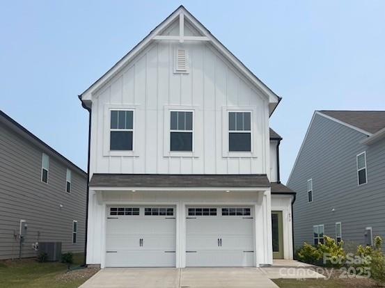 492 Switch St Unit 82Ty, York, SC 29745 - view of front facade featuring board and batten siding, concrete driveway, an attached garage, and cooling unit