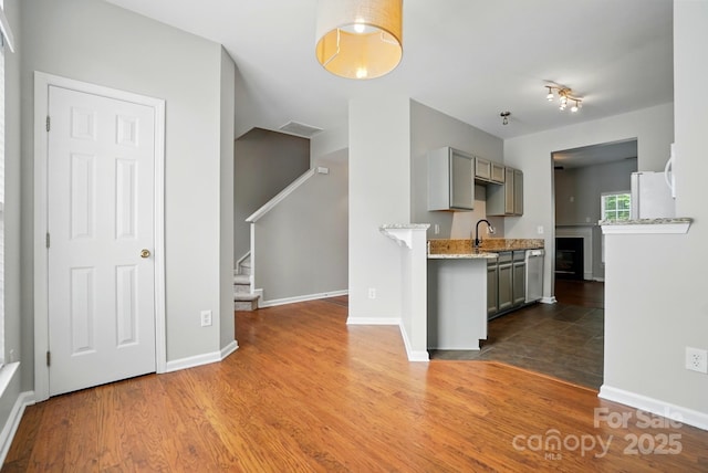 10867 Garden Oaks Ln, Charlotte, NC 28273 - kitchen with gray cabinetry, baseboards, and wood finished floors