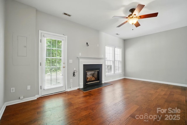 10867 Garden Oaks Ln, Charlotte, NC 28273 - unfurnished living room with a ceiling fan, wood finished floors, a glass covered fireplace, and baseboards