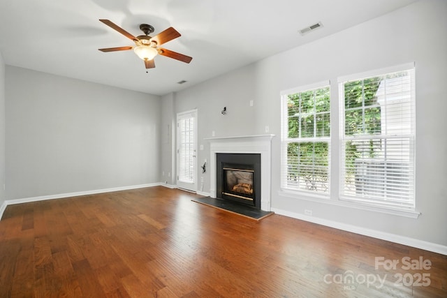 10867 Garden Oaks Ln, Charlotte, NC 28273 - unfurnished living room featuring healthy amount of natural light, ceiling fan, and wood finished floors