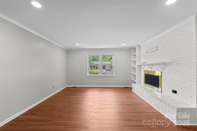 2011 Hampton Heights St, Lenoir, NC 28645 - unfurnished living room with wood finished floors, a brick fireplace, ornamental molding, baseboards, and recessed lighting