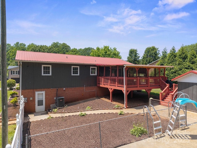 2011 Hampton Heights St, Lenoir, NC 28645 - back of house featuring a deck, metal roof, brick siding, cooling unit, and stairway