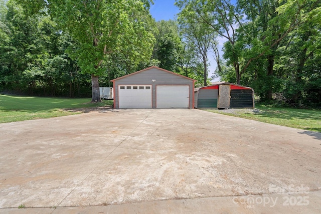 2011 Hampton Heights St, Lenoir, NC 28645 - detached garage with view of wooded area