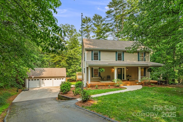 212 Riva Ridge Dr, Fairview, NC 28730 - view of front of house with a detached garage, an outdoor structure, a front yard, and covered porch