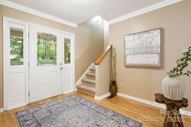 212 Riva Ridge Dr, Fairview, NC 28730 - entrance foyer featuring light wood-type flooring, crown molding, baseboards, and stairway