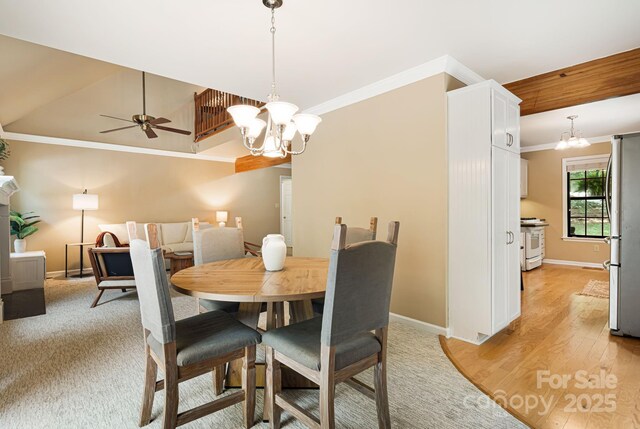 212 Riva Ridge Dr, Fairview, NC 28730 - dining room featuring a chandelier, crown molding, baseboards, a ceiling fan, and light wood-style floors