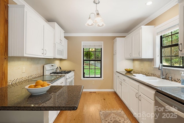 212 Riva Ridge Dr, Fairview, NC 28730 - kitchen featuring white appliances, a sink, white cabinetry, a chandelier, and light wood finished floors