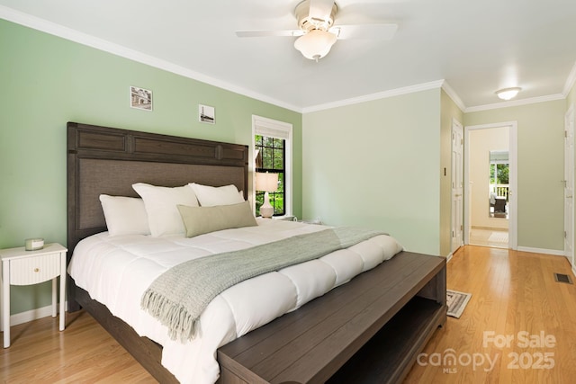 212 Riva Ridge Dr, Fairview, NC 28730 - bedroom with light wood-style floors, crown molding, baseboards, and a ceiling fan