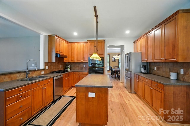 129 N Audubon Ave, Mooresville, NC 28117 - kitchen with black appliances, a center island, under cabinet range hood, dark countertops, and recessed lighting