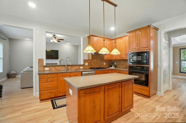 129 N Audubon Ave, Mooresville, NC 28117 - kitchen featuring black appliances, light wood-style floors, backsplash, a kitchen island, and recessed lighting