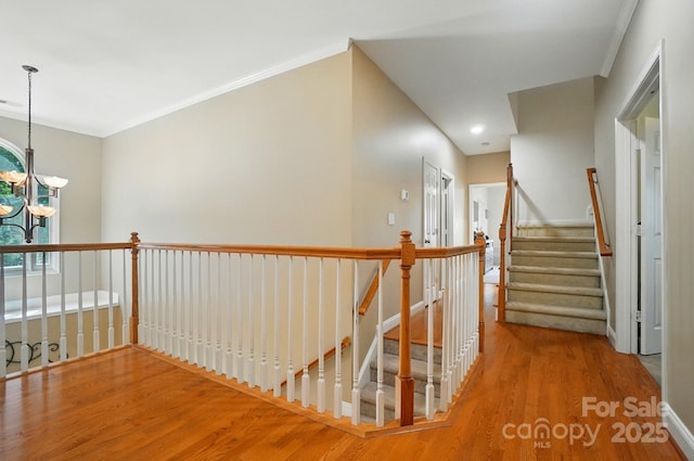 129 N Audubon Ave, Mooresville, NC 28117 - hall with a chandelier, wood finished floors, an upstairs landing, ornamental molding, and recessed lighting
