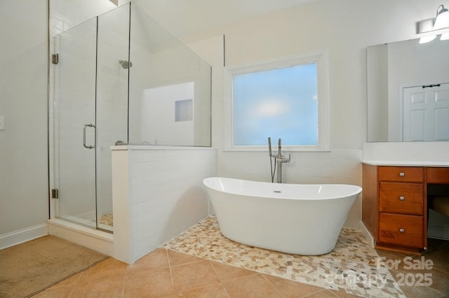 129 N Audubon Ave, Mooresville, NC 28117 - full bath with a stall shower, a freestanding bath, vanity, and tile patterned flooring