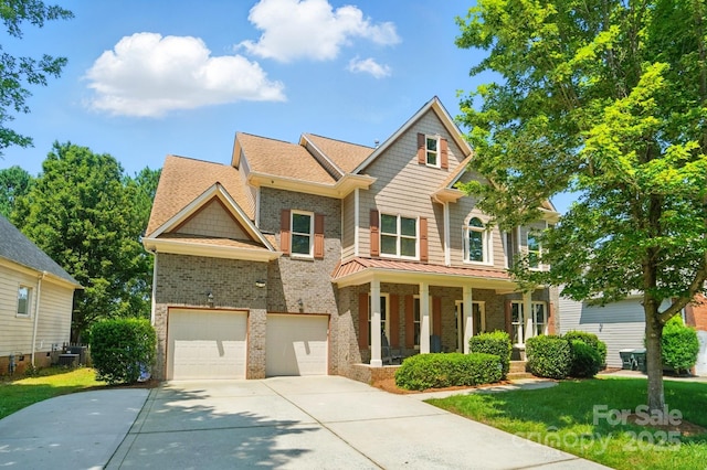 129 N Audubon Ave, Mooresville, NC 28117 - craftsman-style home featuring concrete driveway, covered porch, brick siding, a garage, and a front yard