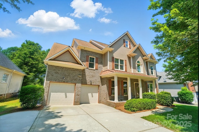 129 N Audubon Ave, Mooresville, NC 28117 - craftsman inspired home featuring driveway, covered porch, an attached garage, brick siding, and a standing seam roof