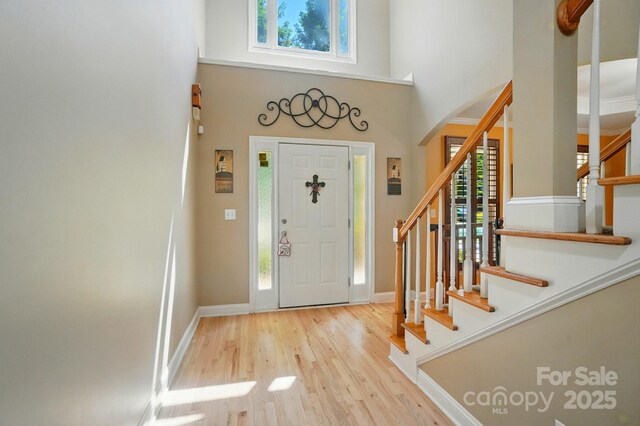 129 N Audubon Ave, Mooresville, NC 28117 - foyer entrance featuring wood finished floors, arched walkways, a towering ceiling, and stairway